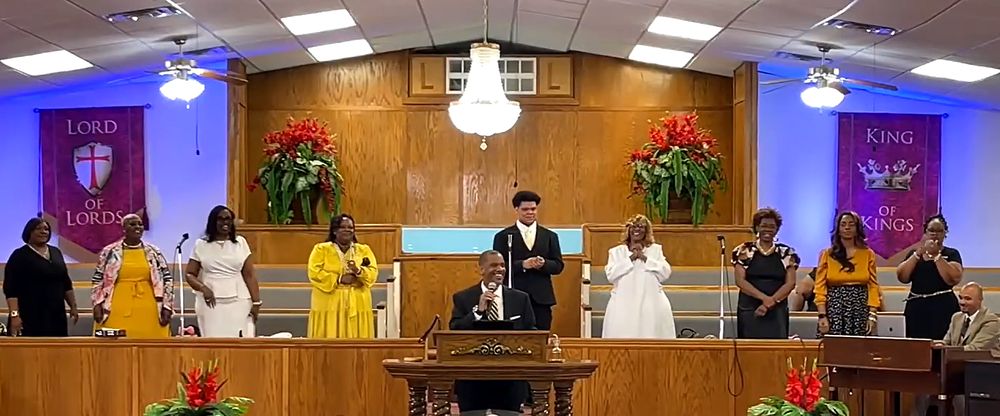 Singers and the pastor leading worship on First Sunday at Lakeview Community Temple